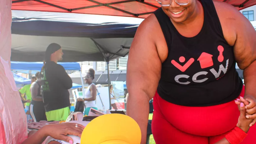 Massage therapist demonstrates on guest at FITMIX FEST