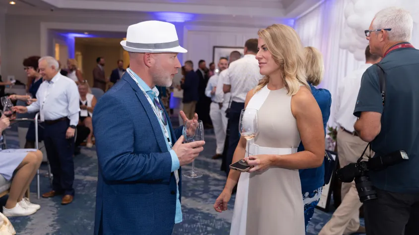 An event photo of a man and woman having a discussion. 