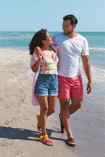 A couple walks on the beach