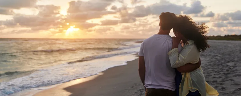 A couple enjoys watching the sunset on Captiva Island