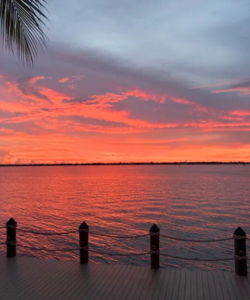 A vibrant sunset over the Caloosahatchee River in downtown Fort Myers' Culinary District